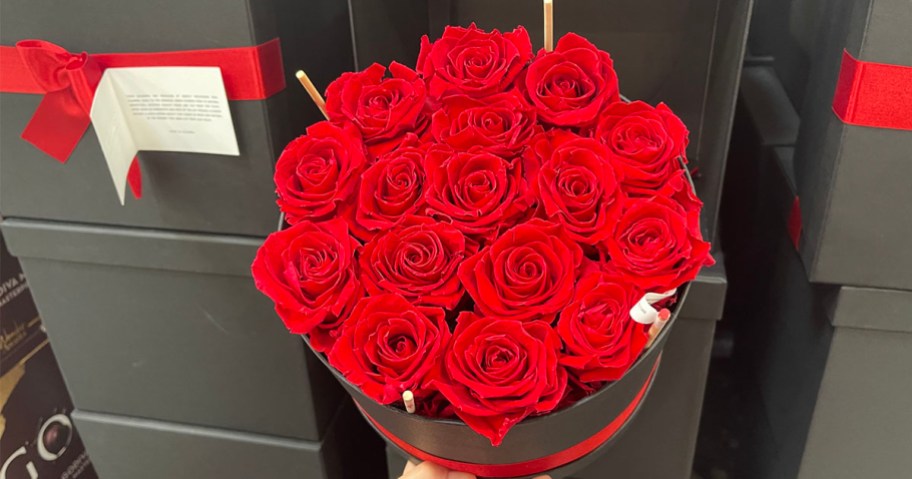 womans hand holding forever roses box in costco