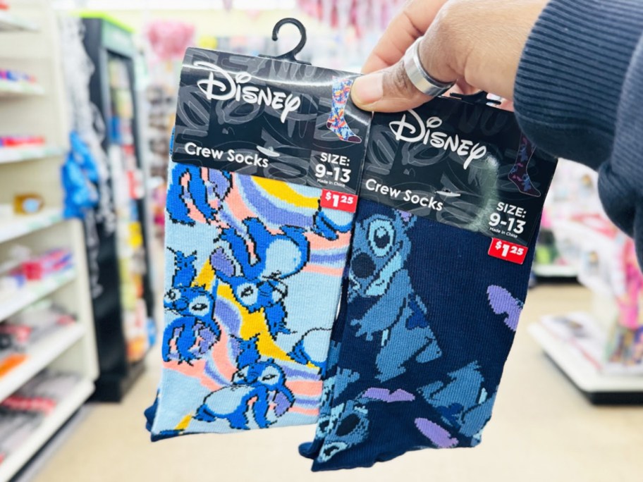 hand holding up two pairs of Disney Stitch Crew Socks