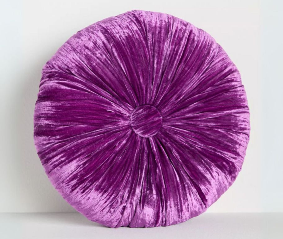 a round purple velvet pillow