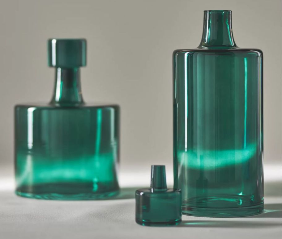 two round green decanter bottles