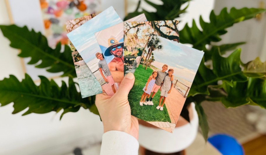 hand holding photo magnets in air