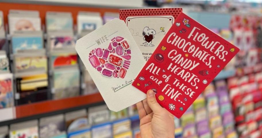 hand holding hallmark valentine's day cards in store