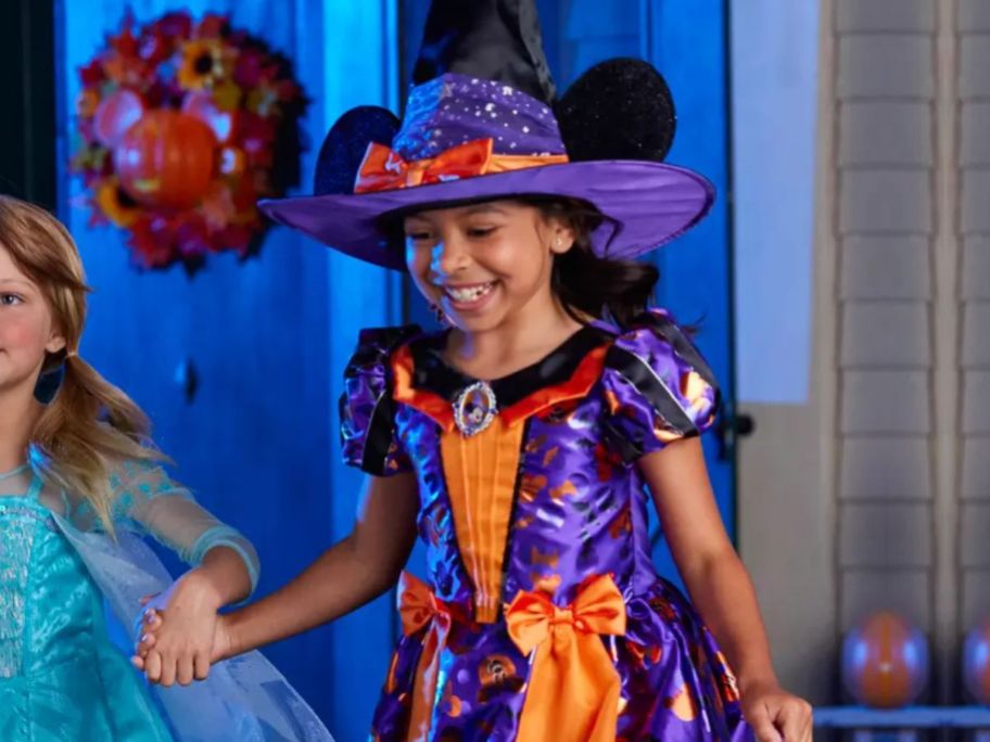 Girl wearing a Minnie Mouse Witch Costume