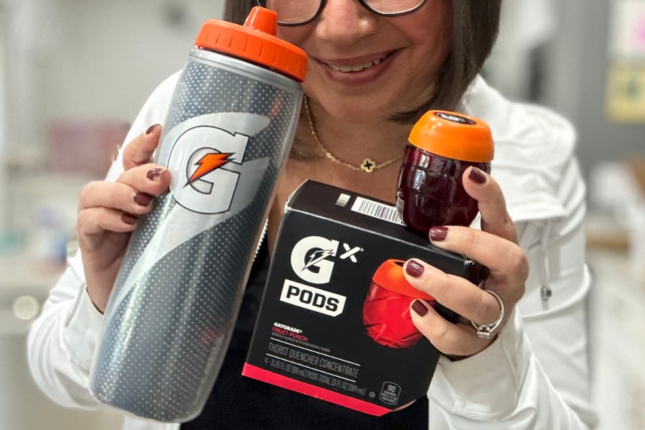 woman holding gatorade bottle and pods