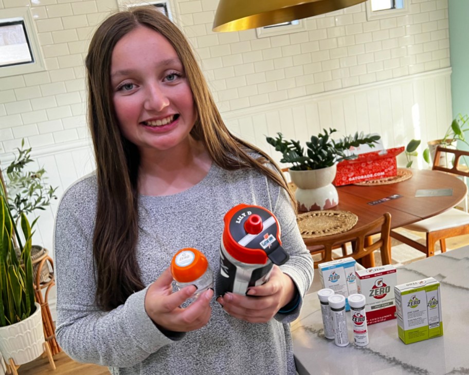 girl holding gatorade pods and bottle