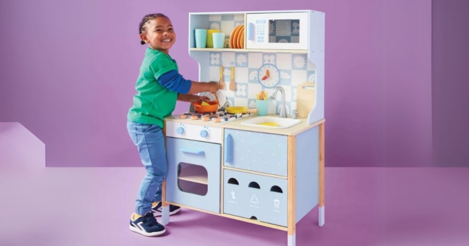 child playing with gigglescape play kitchen set