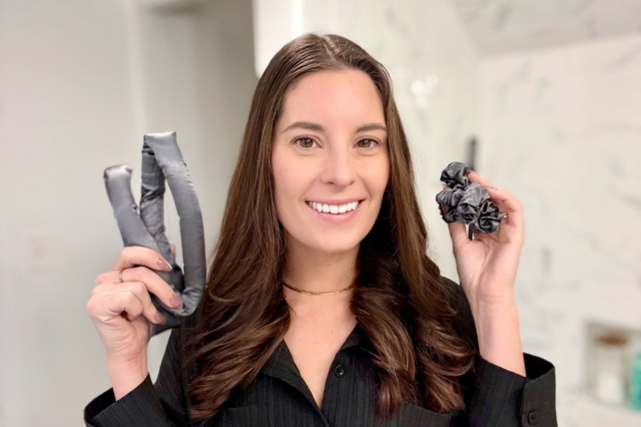 woman in a black robe holding up pieces from a Kitsch Heatless Curling Set