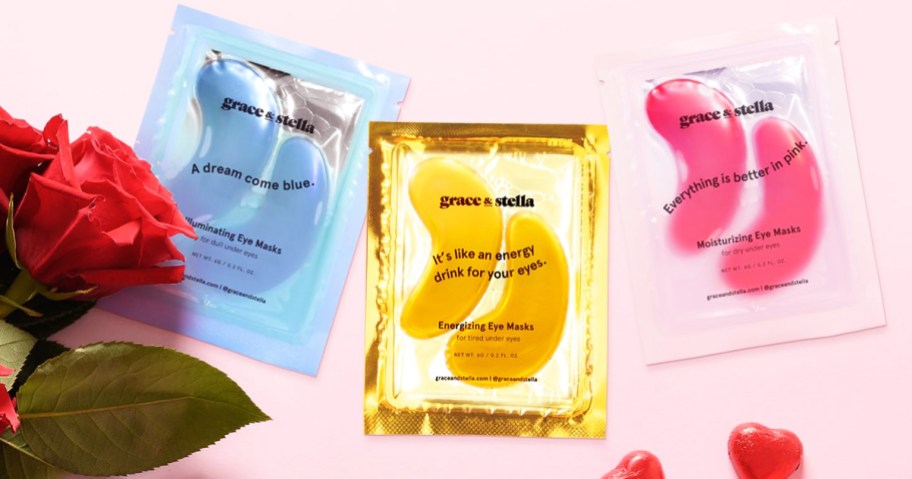 blue, gold, and pink pairs of Grace & Stella Under-Eye Masks near a red rose