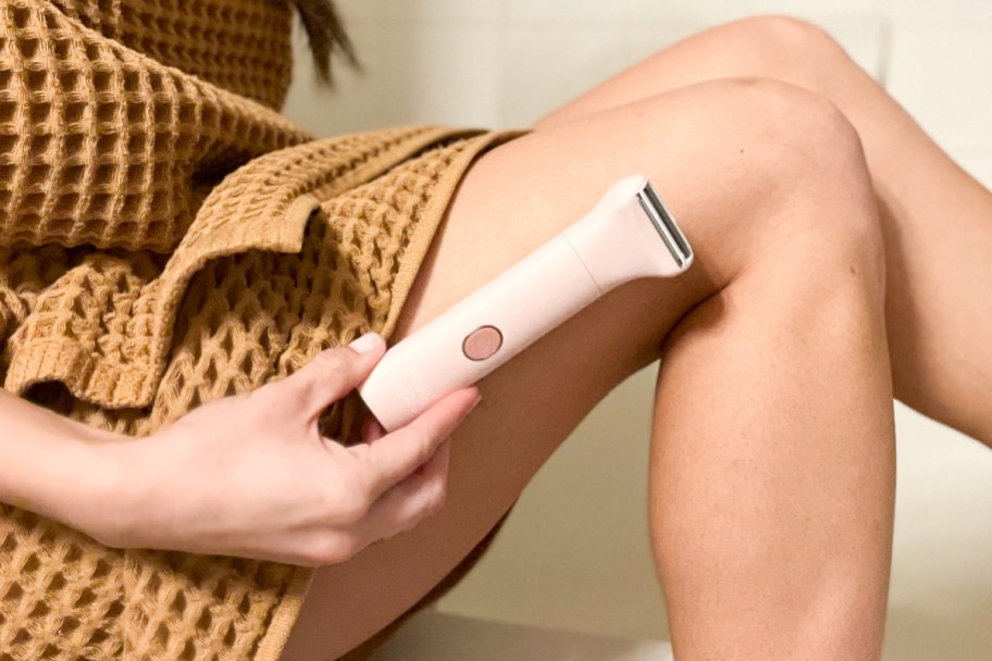 holding electric razor against leg