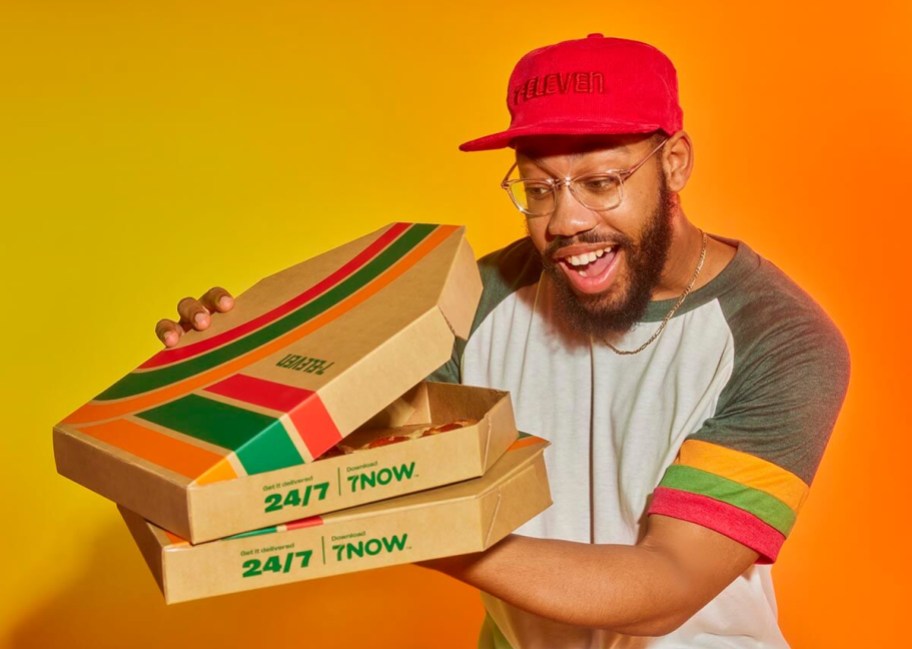 man looking into pizza box