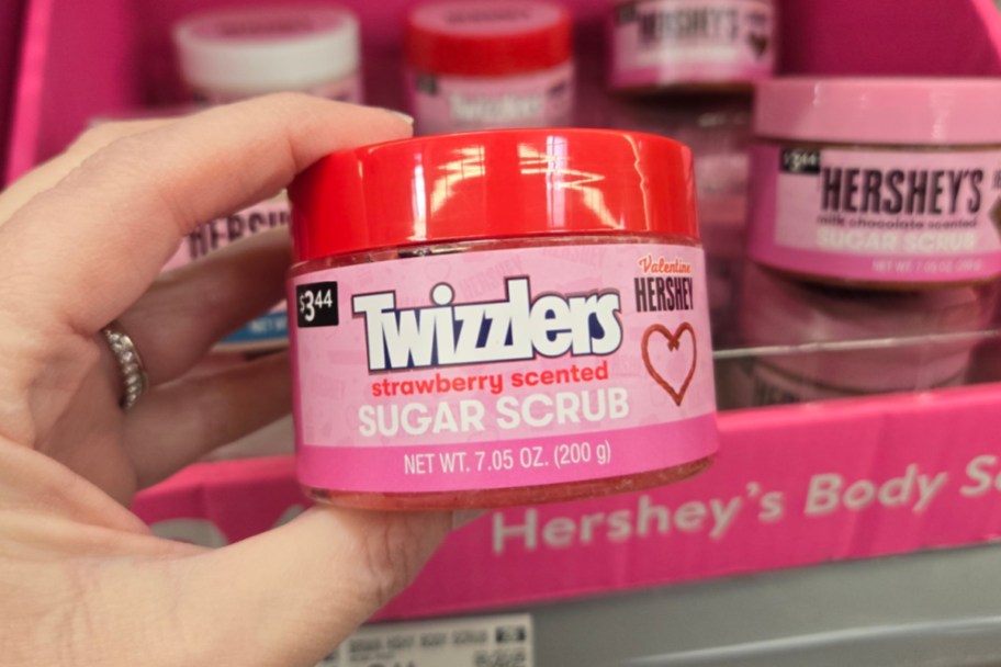 hand holding twizzlers body scrub in store