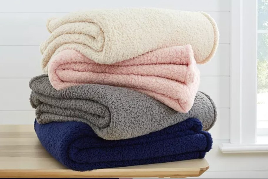 stack of sherpa throw blankets