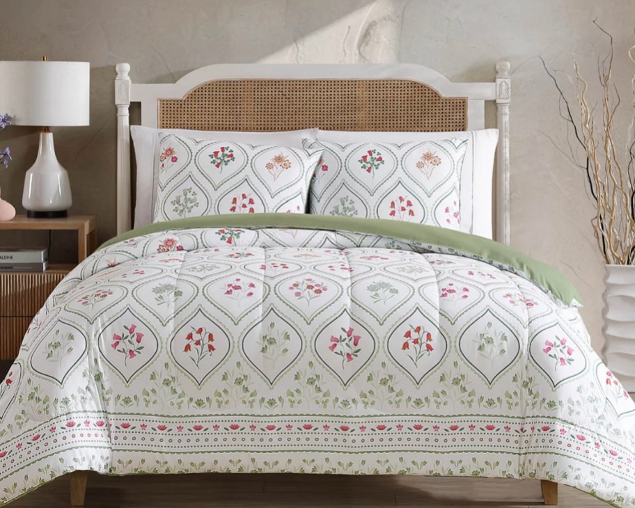 green floral comforter set on bed