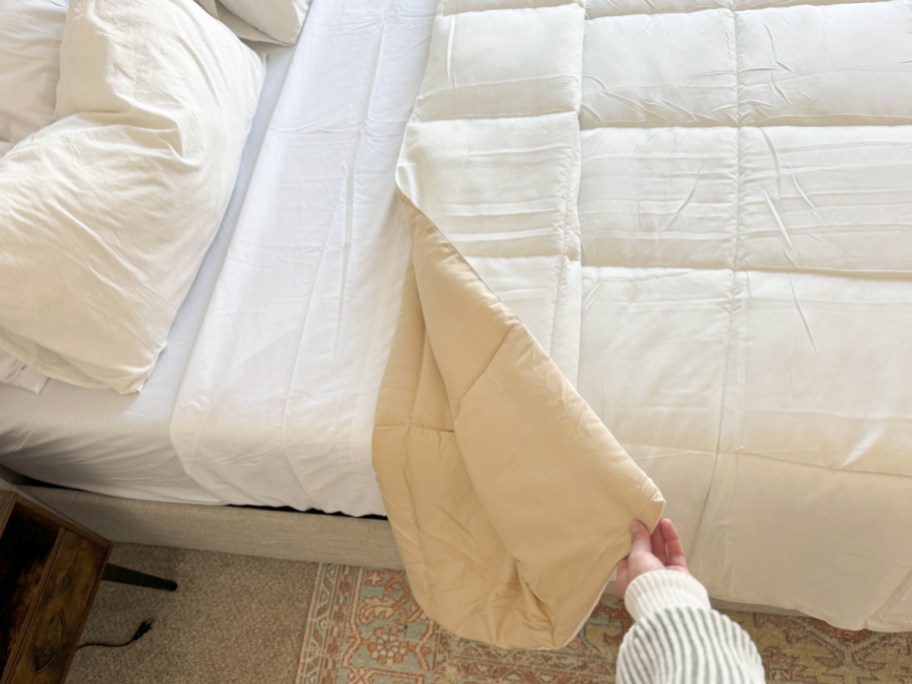 hand grabbing reversible comforter