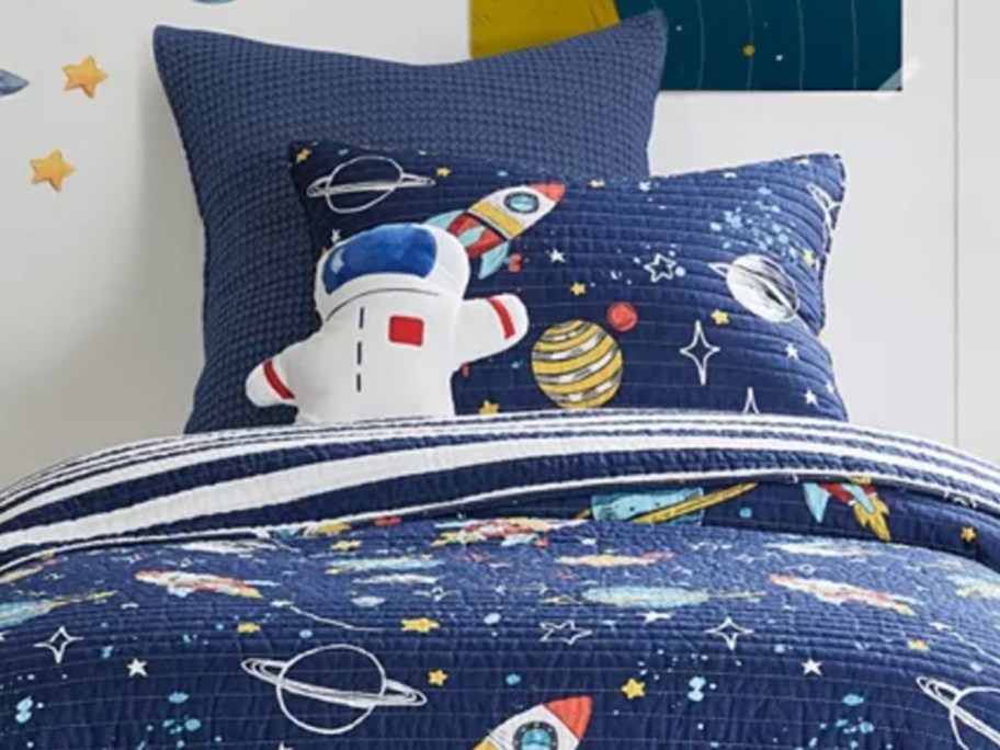 astronaut pillow on galaxy bedding