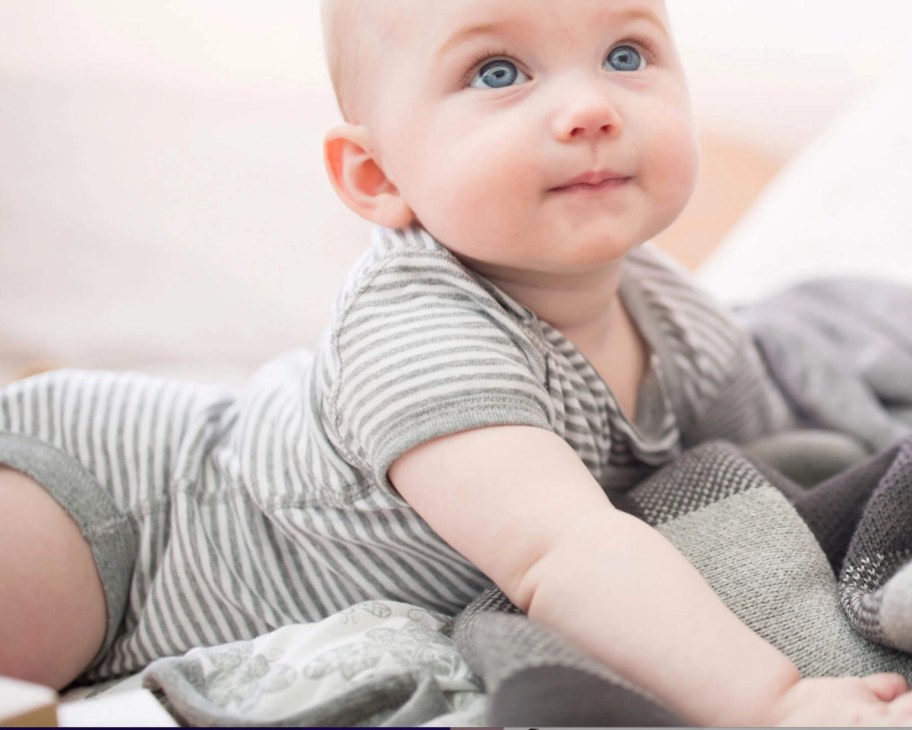 baby in grey stripe bodysuit