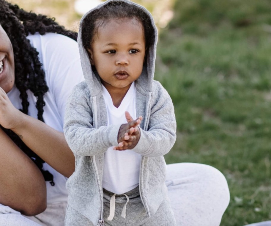 baby in grey jacket