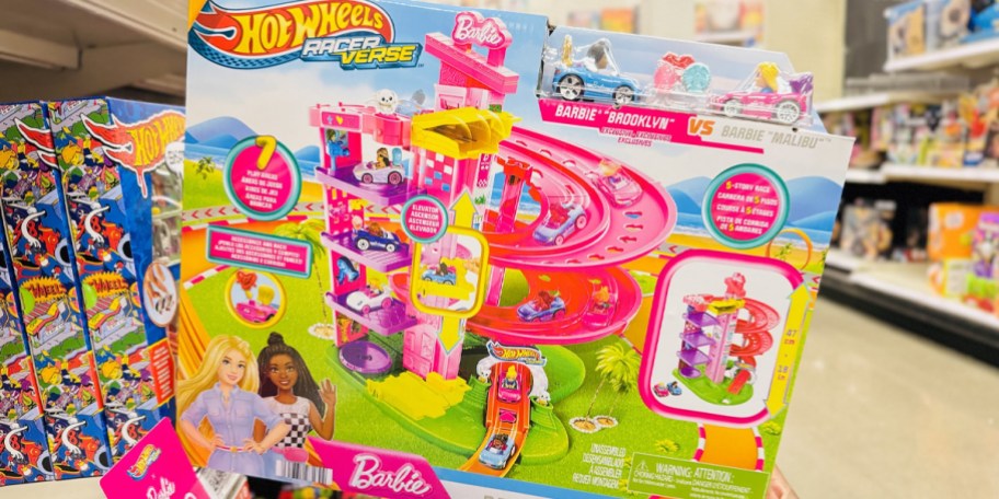 hand holding barbie hot wheels playset