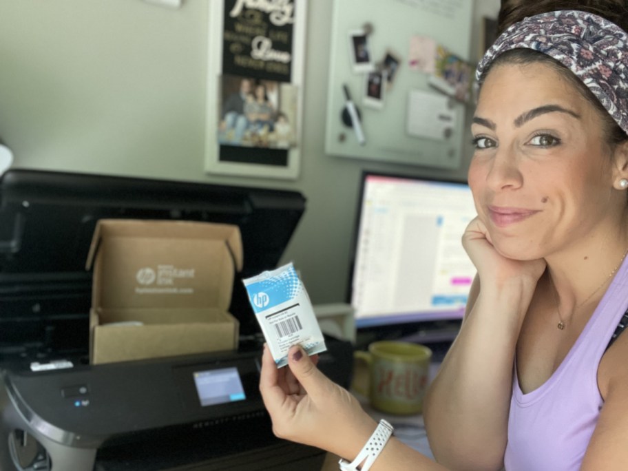 Woman holding HP Instant Ink Cartridge