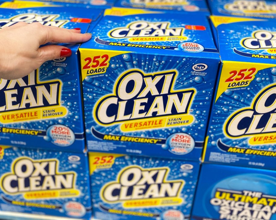 woman holding blue box of oxiclean at sams club