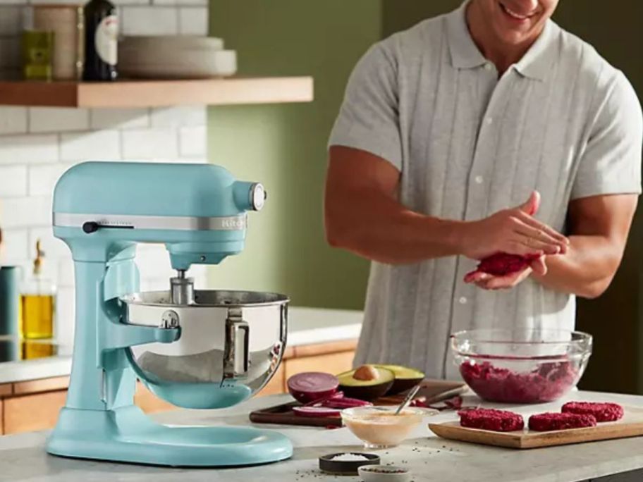 man using a kitchenaid mixer to make hamburger patties