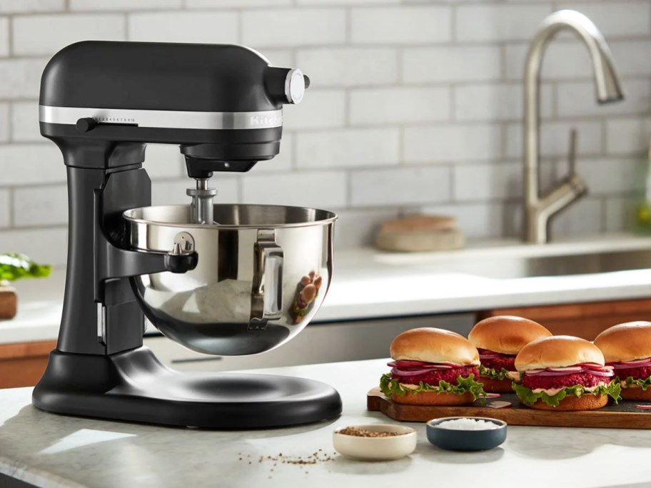 black kitchenaid mixer on counter next to plate of burgers