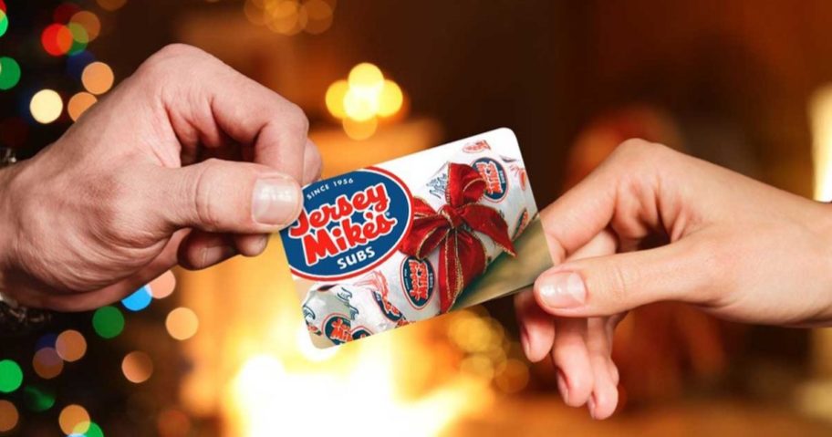 2 hands holding a Jersey Mike's gift card