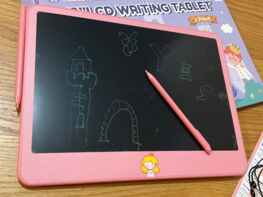 pink writing table with castle drawing on it