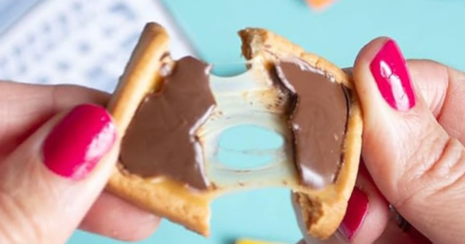 person breaking open a michel et augustin cookie