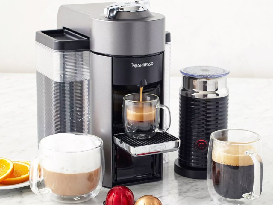 Nespresso Evoluo machine brewing coffee with the Aeroccino milk frother next to it