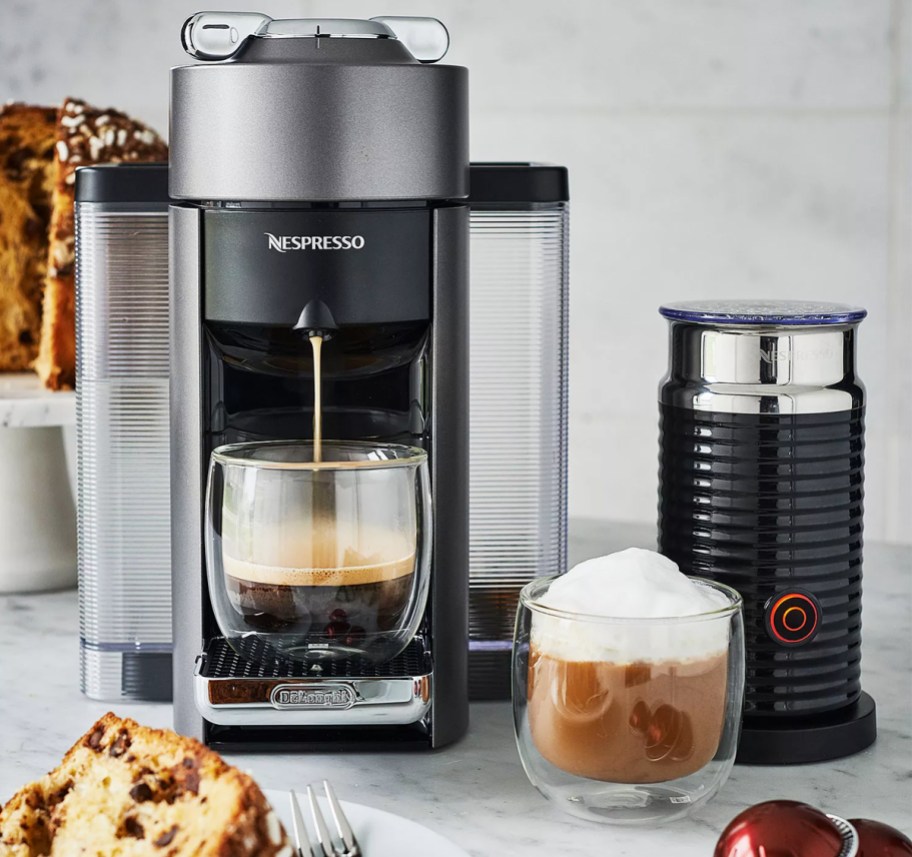 Nespresso Evoluo machine brewing coffee with the Aeroccino milk frother next to it