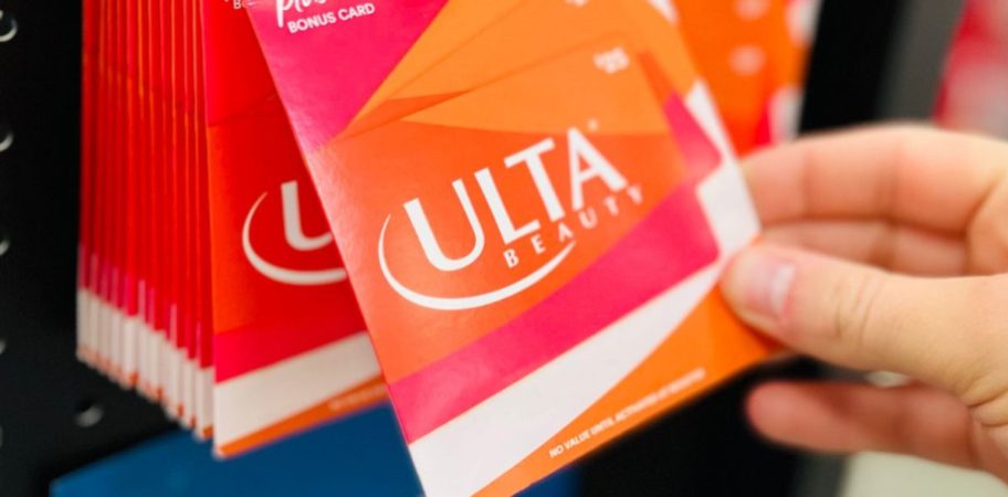 hand taking an ulta gift card from display 