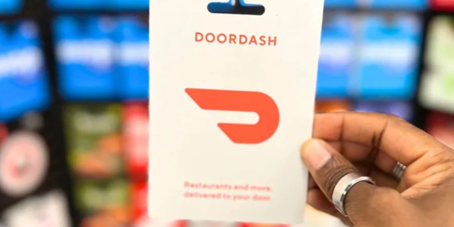 hand holding doordash gift card