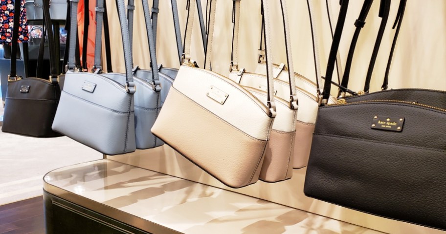 display of kate spade crossbody bags in store