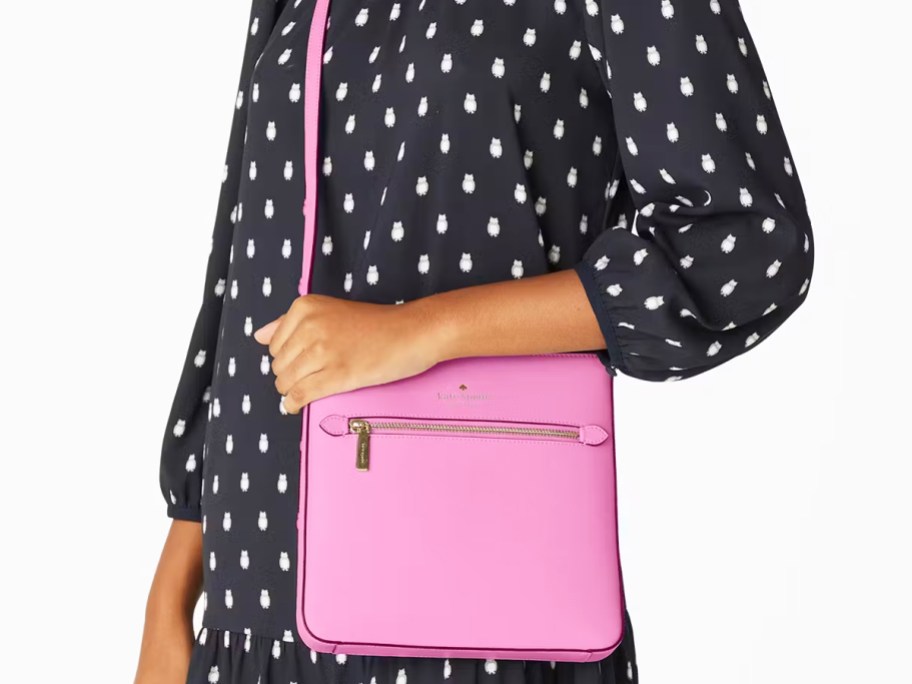 woman in an owl print dress with a pink square crossbody bag