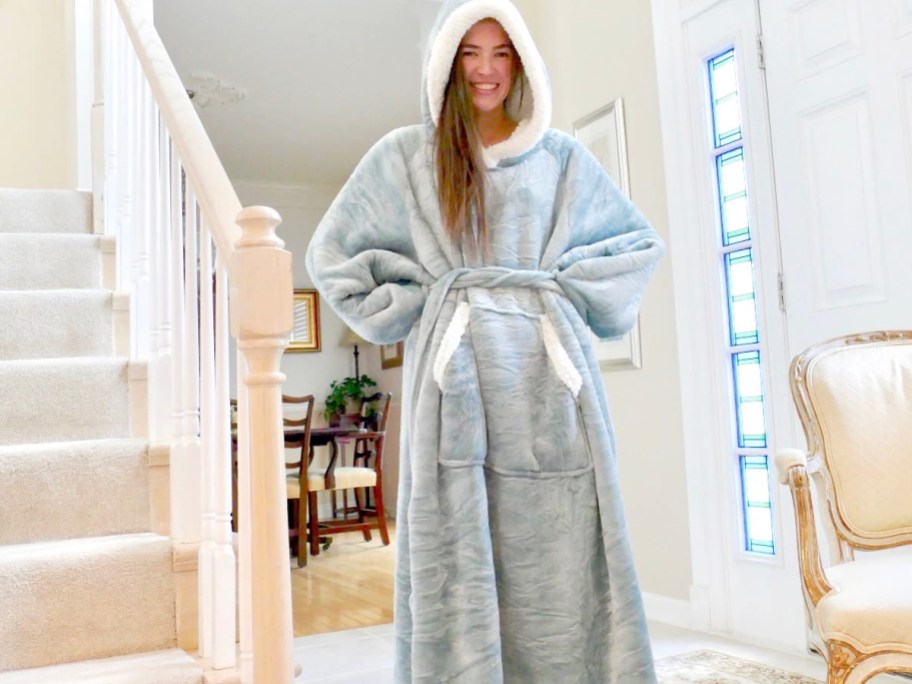 woman wearing blue blanket hoodie in living room 