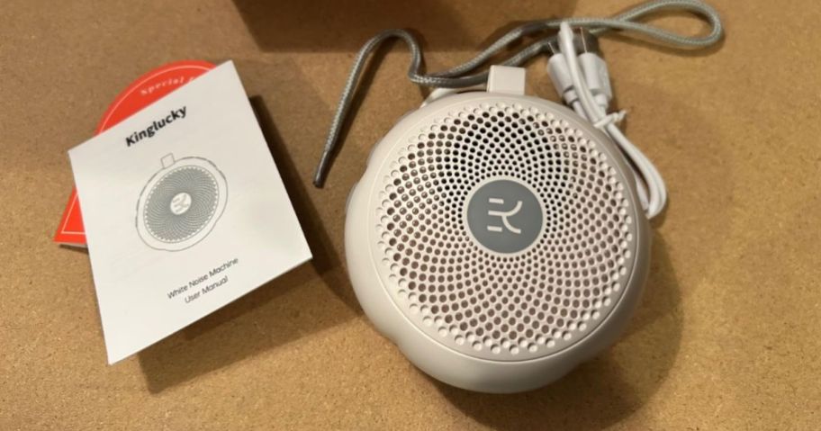 A white noise machine with booklet