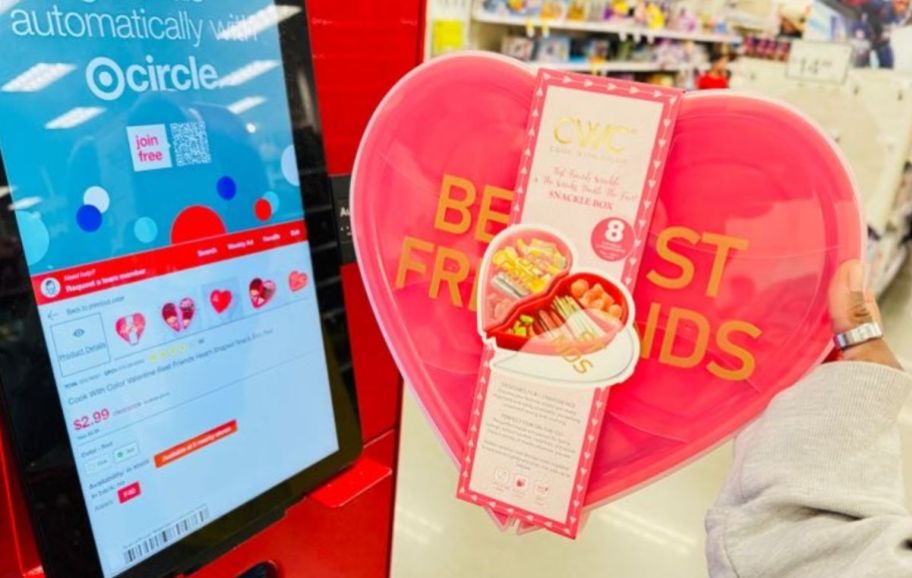 womans hand holding a snackle box next to a price scanner