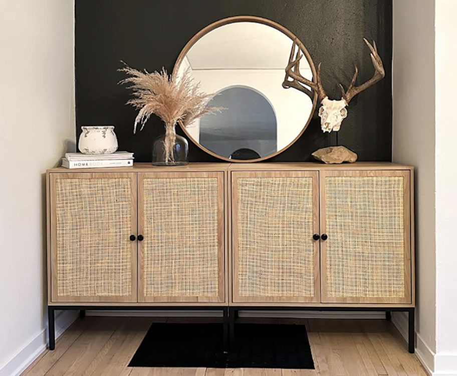 caned table in nook with black wall and decor