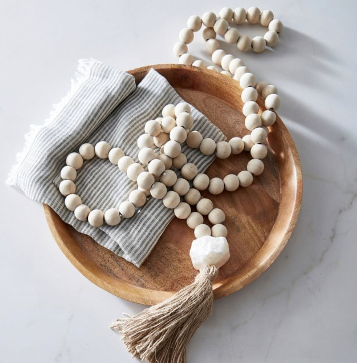 wood bead garland in wood bowl 