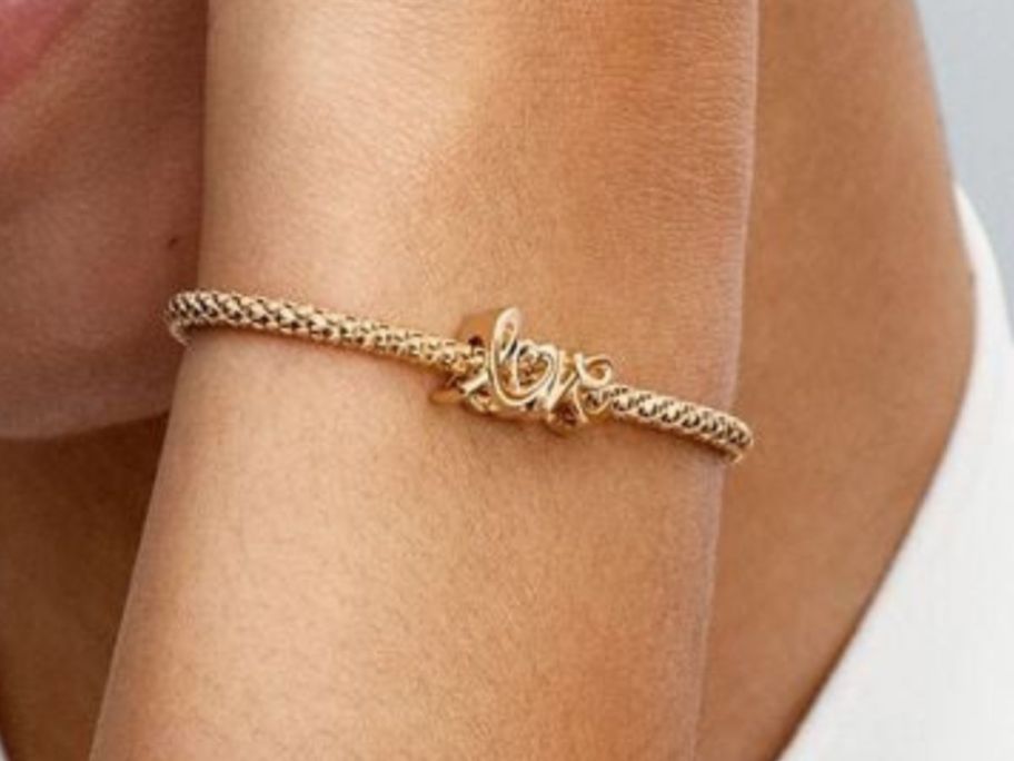 Pandora Handwritten Love Charm on bracelet on woman's wrist