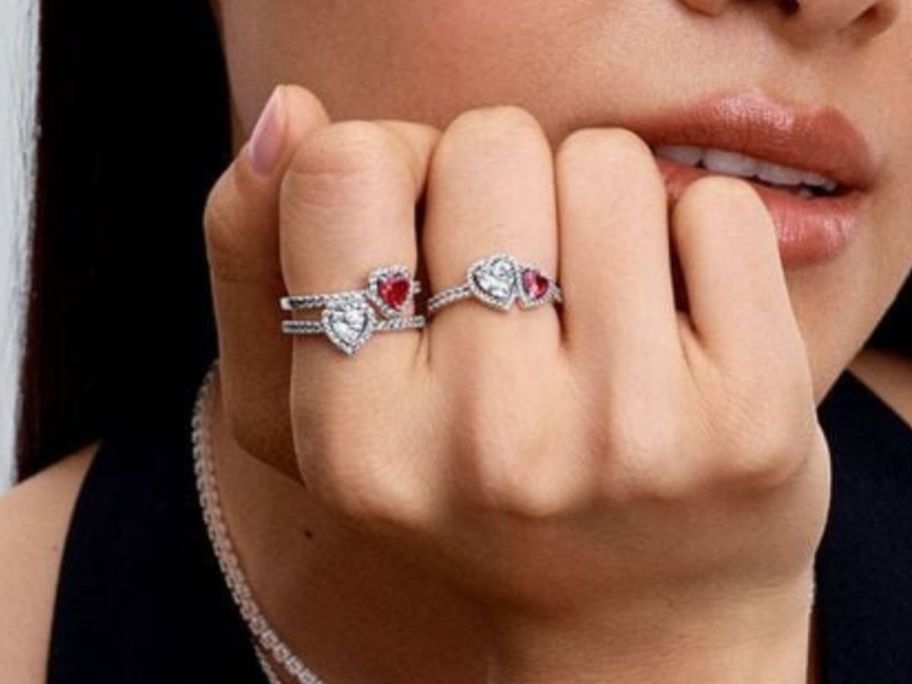 woman wearing two Pandora Halo Hearts Rings on fingers