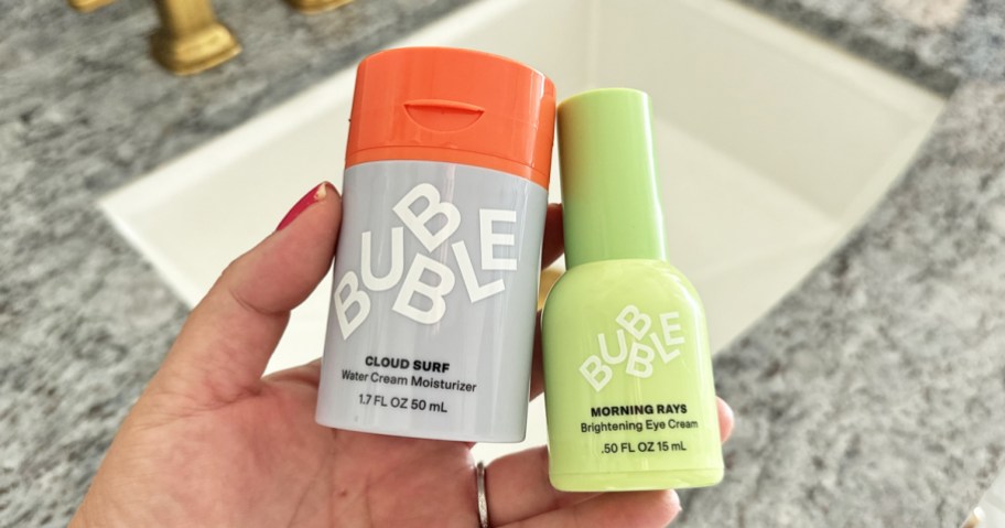 hand holding two Bubble Skincare products