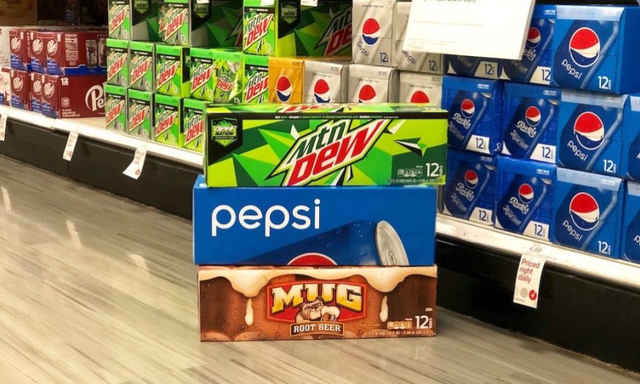 boxes of soda cans stacked in a store