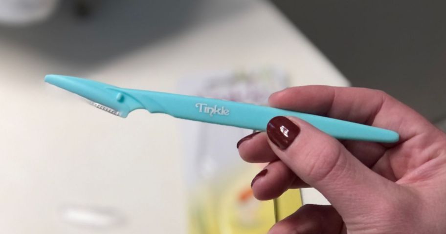 Dorco Tinkle Razor Dermaplane in hand