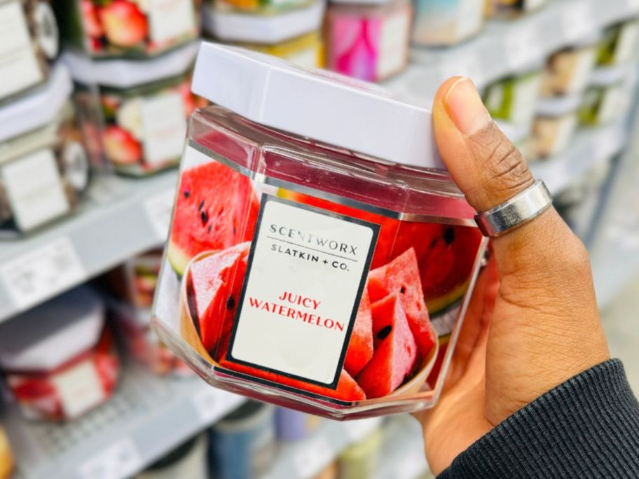 Hand holding a Scentworx Juicy Watermelon 14.5oz Candle