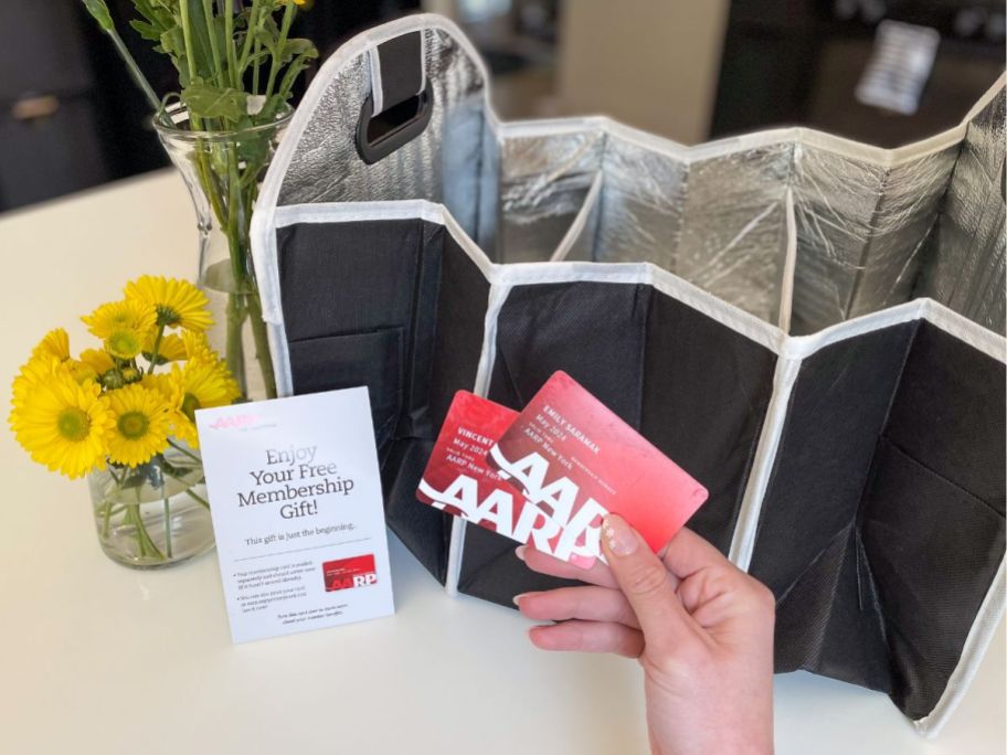 AARP cards in front of a free tote on a counter top 