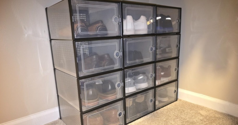 a set of twelve black and clear large shoe storage boxes stacked in a closet with shoes in them