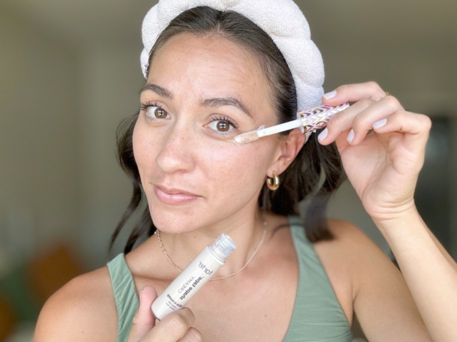 woman putting shape tape concealer under eye