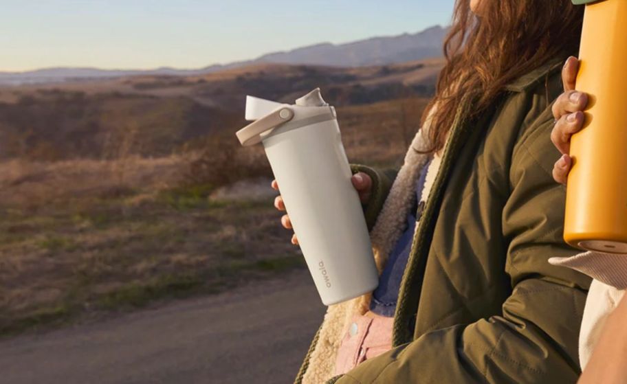 a person shown holding an owala water bottle 